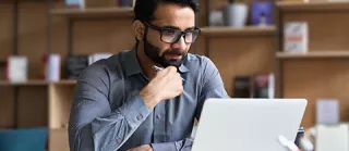 clinician at home on laptop